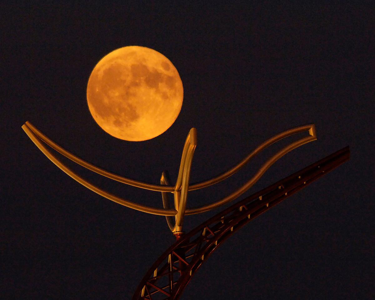 A full "corn moon" rises above a large metal sculpture on the campus of the University of Minnesota, Duluth, Thursday, Sept. 7, 2006, in Duluth, Minn. (Jack Rendulich/AP)