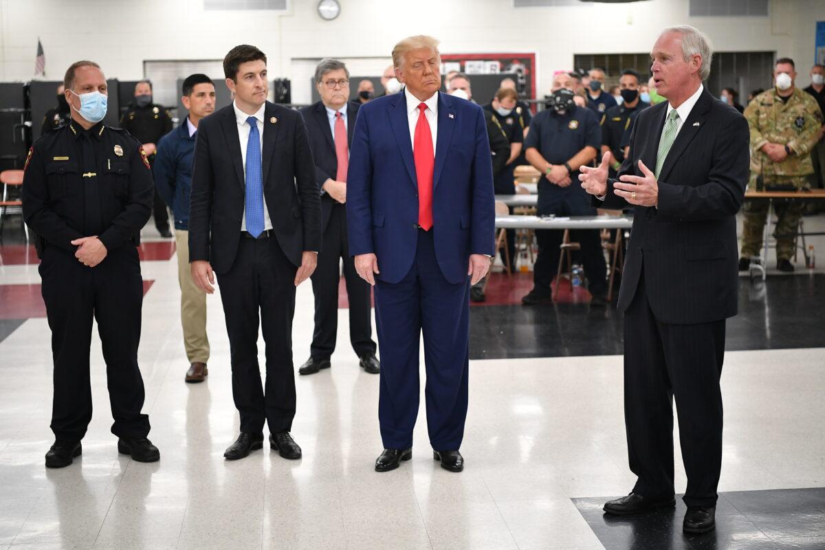  Sen Ron Johnson (R-Wis.), right, speaks during a tour of an emergency operations center at Mary D. Bradford High School in in Kenosha, Wis., during a visit from President Donald Trump, on Sept. 1, 2020. (Mandel Ngan/AFP via Getty Images)