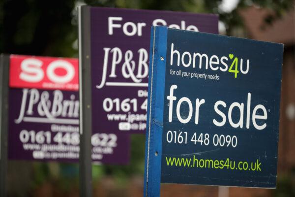 For sale boards stand outside homes in Didsbury in Manchester, England, on Aug. 2, 2016. (Christopher Furlong/Getty Images)