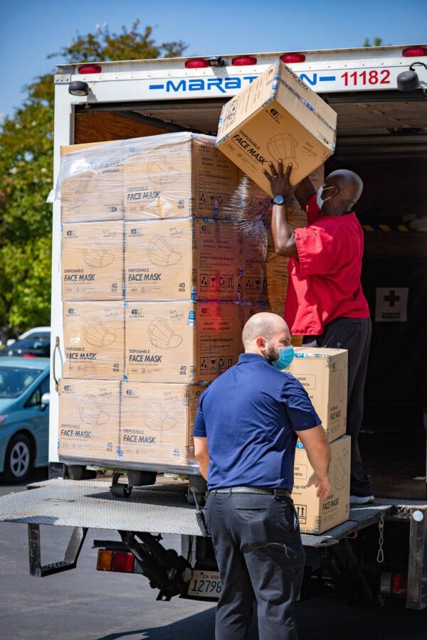 Boxes of protective face masks are loaded onto a truck in the Richard Nixon Library parking lot in Yorba Linda, Calif., on Sept. 1, 2020. (John Fredricks/The Epoch Times)