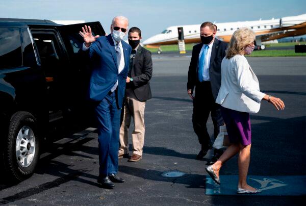 Democratic presidential candidate Joe Biden, with his wife Dr. Jill Biden (R), waves as he boards his plane in New Castle, Del., on Sept. 3, 2020. (Jim Watson / AFP via Getty Images)