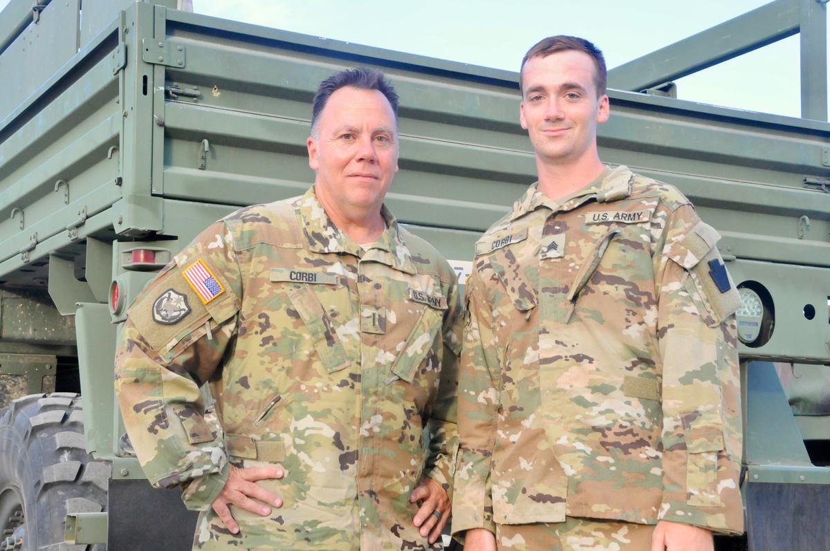 U.S. Army CW5 David Corbi (L) and Sgt. David Corbi pose for a photo after a promotion ceremony in their honor at the 28th ECAB's mobilization station in Fort Hood, Texas. (<a href="https://www.dvidshub.net/image/6316374/father-and-son-deployed-together-promoted">Capt. Travis Mueller</a>/DVIDSHUB)