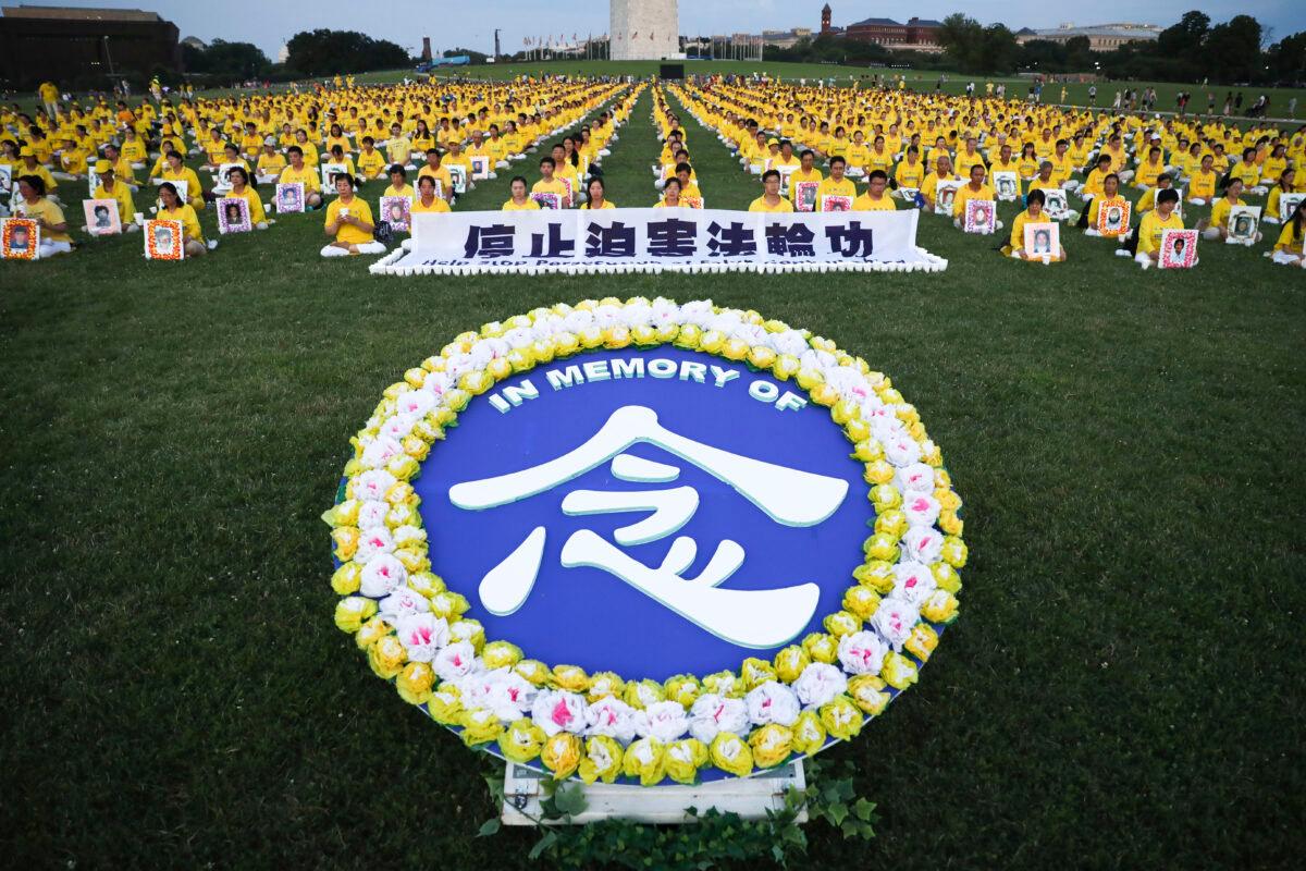 Falun Gong practitioners take part in a candlelight vigil commemorating the 20th anniversary of the persecution of Falun Gong in China, on the West Lawn of Capitol Hill on July 18, 2019. (Samira Bouaou/The Epoch Times)