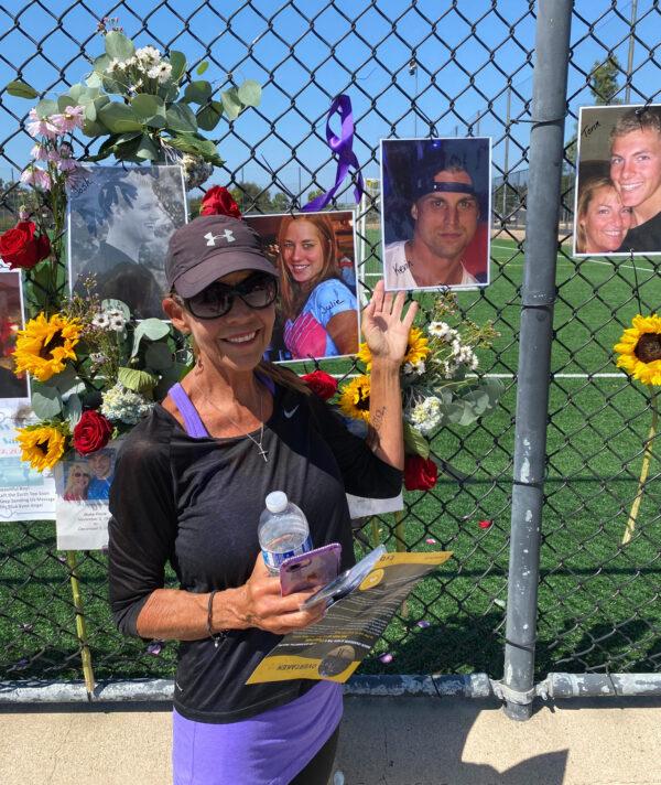 Callie Fortin stands next to a picture of her son, Kevin, a military veteran who passed away from drugs in 2017, at an International Overdose Awareness Day gathering in Laguna Niguel, Calif., on Aug. 31, 2020. (Chris Karr/The Epoch Times)