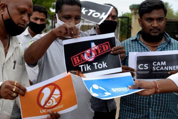 Members of the City Youth Organisation hold posters with the logos of Chinese apps in support of the Indian government for banning the wildly popular video-sharing TikTok app, in Hyderabad, India, on June 30, 2020. This month India permanently banned 59 Chinese apps including Tiktok. (Noah Seelam/AFP via Getty Images)