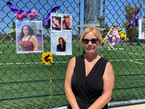 Cindy Trott stands in front of a photo of her daughter on International Overdose Awareness Day in Laguna Niguel, Calif., on Aug. 31, 2020. (Chris Karr/The Epoch Times)