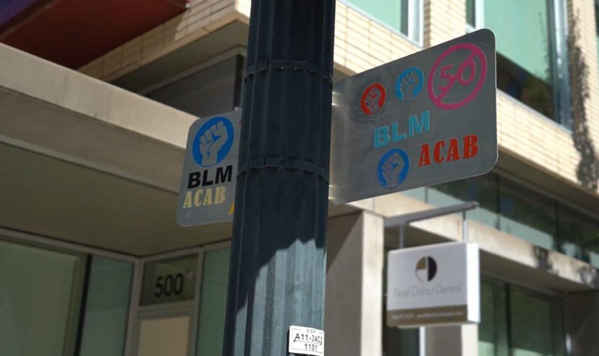 In this still image from video, a sign is emblazoned with Black Lives Matter and Antifa symbology outside Pearl District Dental, in Portland, Ore., on Sept. 2, 2020. (Roman Balmakov/The Epoch Times)