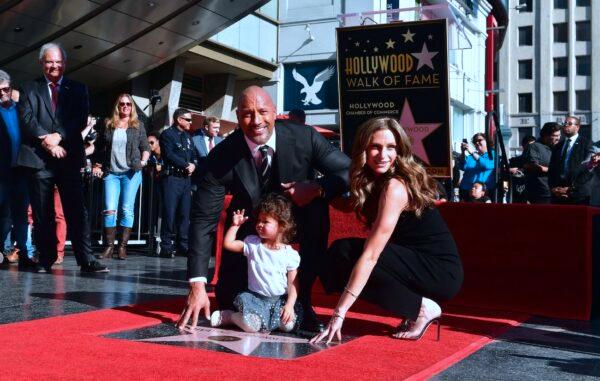 Dwayne Johnson and his wife Lauren Hashian and daughter Jasmine pose as his Hollywood Walk of Fame Star is unveiled in Hollywood, California on Dec. 13, 2017. (Frederic J. Brown/AFP via Getty Images)