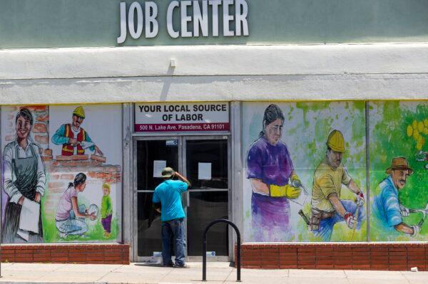 A person looks inside the closed doors of the Pasadena Community Job Center during the CCP virus pandemic in Pasadena, Calif., on May 7, 2020. (Damian Dovarganes/AP Photo)