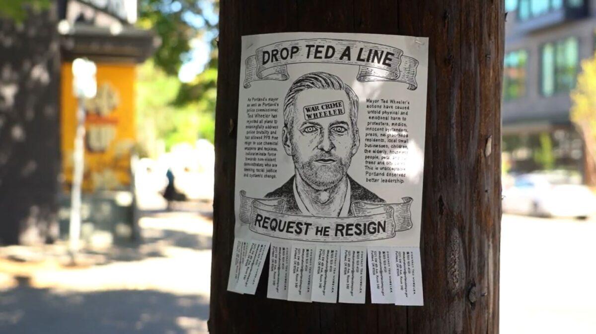 In this still image from video, a sign calling on people to request the resignation of Portland Mayor and Police Commissioner Ted Wheeler is seen in Portland, Ore., on Sept. 2, 2020. (Roman Balmakov/The Epoch Times)