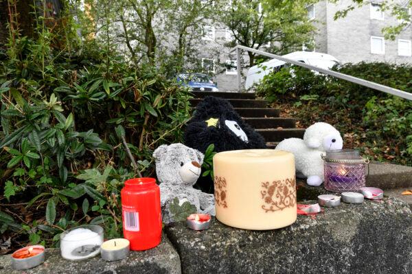 A Teddy bear and candles are set in front of an apartment building, where five dead children were found in Solingen, Germany, on Sept. 4, 2020. (Martin Meissner/AP Photo)