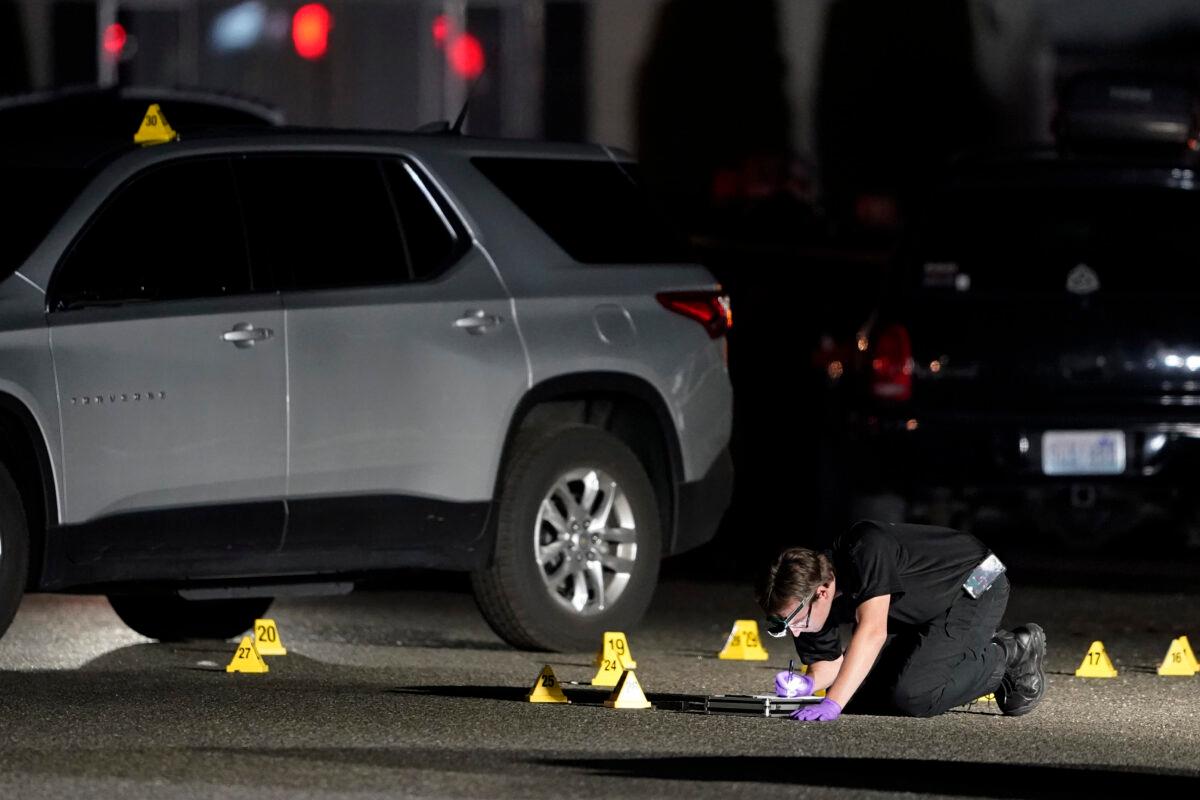 A Washington State Patrol Crime Lab worker looks at evidence markers in Lacey, Wash., in the early morning hours of Sept. 4, 2020. (Ted Warren/AP Photo)