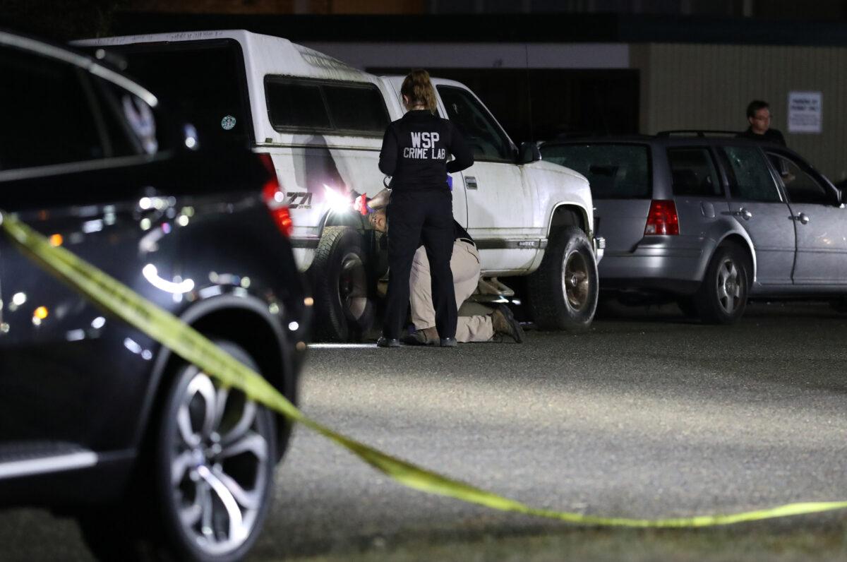 Investigators with the Washington State Crime Lab collect evidence at Tanglewilde Terrace, where law enforcement officers shot a man reported to be Michael Forest Reinoehl, in Lacey, Wash., Sept. 3, 2020. (Caitlin Ochs/Reuters)