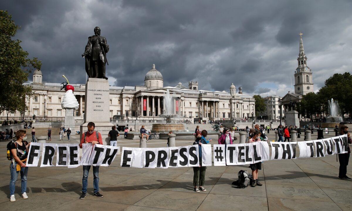 Extinction Rebellion demonstrators hold up a banner in Trafalgar Square, in London, on Sept. 5, 2020. (Hollie Adams/Getty Images)