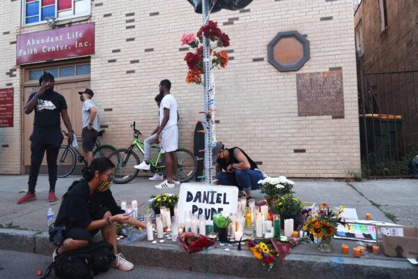People light candles at a make shift memorial at the site where Daniel Prude was arrested in Rochester, N.Y., Sept. 3, 2020. (Michael M. Santiago/Getty Images)