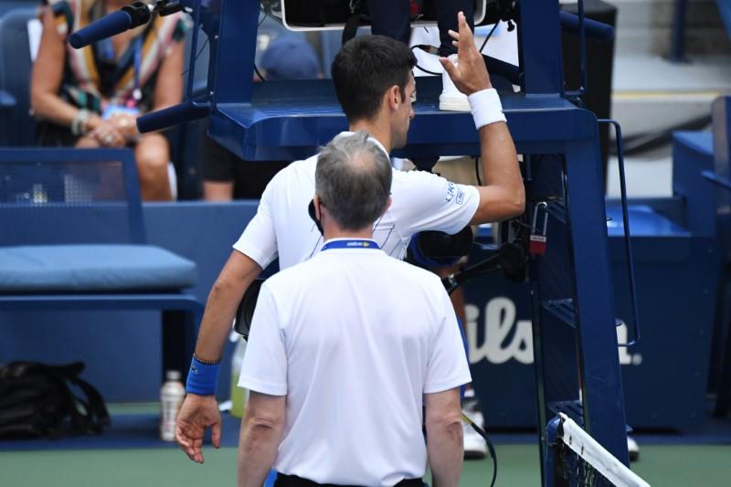 Novak Djokovic of Serbia discusses with a tournament official after being defaulted for striking a lines person with a ball against Pablo Carreno Busta of Spain (not pictured) on day seven of the 2020 U.S. Open tennis tournament at USTA Billie Jean King National Tennis Center in Flushing Meadows, New York, on Sept. 6, 2020. (Danielle Parhizkaran-USA TODAY Sports via Reuters)