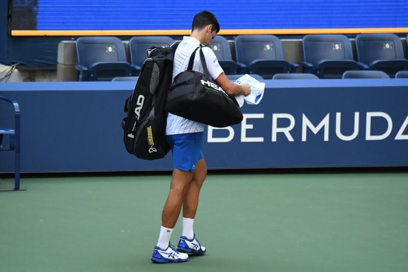 Novak Djokovic of Serbia leaves the court after being defaulted for striking a lines person with a ball against Pablo Carreno Busta of Spain (not pictured) on day seven of the 2020 U.S. Open tennis tournament at USTA Billie Jean King National Tennis Center in Flushing Meadows, New York, on Sept. 6, 2020. (Danielle Parhizkaran-USA TODAY Sports via Reuters)