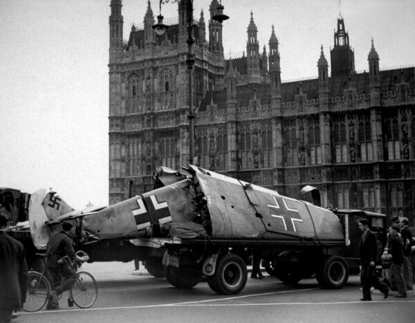 A German Messerschmitt fighter plane is paraded outside the Houses of Parliament in London after being shot down by Allied Spitfire pilots, circa 1940. (Keystone/Getty Images)