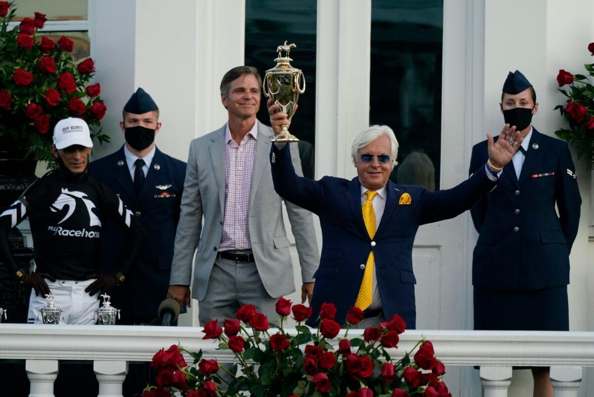 Trainer Bob Baffert holds the trophy after John Velazquez (L) rode Authentic to victory in the 146th running of the Kentucky Derby at Churchill Downs, in Louisville, Ky., on Sept. 5, 2020. (Jeff Roberson/AP Photo)