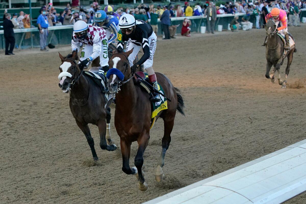 Jockey John Velazquez riding Authentic (18) crosses the finish line ahead of Jockey Manny Franco riding Tiz the Law to win the 146th running of the Kentucky Derby at Churchill Downs, in Louisville, Ky., on Sept. 5, 2020. (Jeff Roberson/AP Photo)