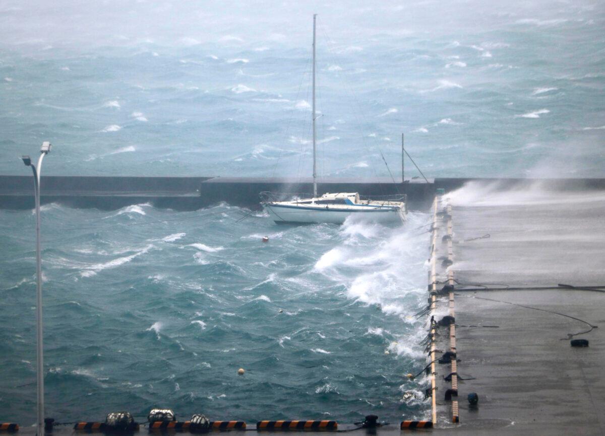 High waves pound a fishing port in Amami city, Kagoshima prefecture, southwestern Japan as a typhoon hits the region, on Sept. 6, 2020. (Kyodo News via AP)