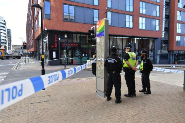 Police officers stand at a cordon in Hurst Street in Birmingham after a number of people were stabbed in the city center, on Sept. 6, 2020. (Jacob King/PA via AP)
