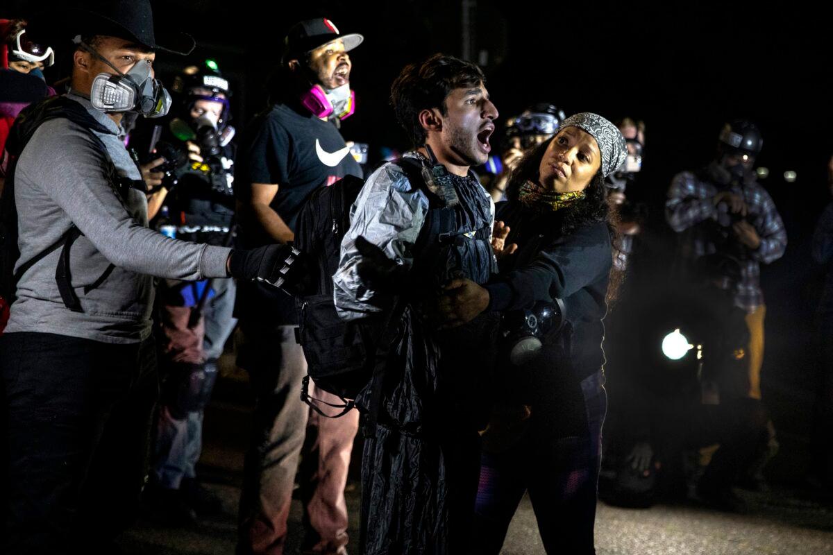 A man screams at police during a march that turned into a riot, in Portland, Ore., Sept. 5, 2020. (Paula Bronstein/AP Photo)