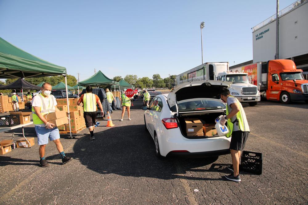 Central Texas Food Bank volunteers distribute emergency food supplies at a high school parking lot in Austin, Texas, on Aug. 20, 2020 (Vic Hinterlang/Shutterstock)