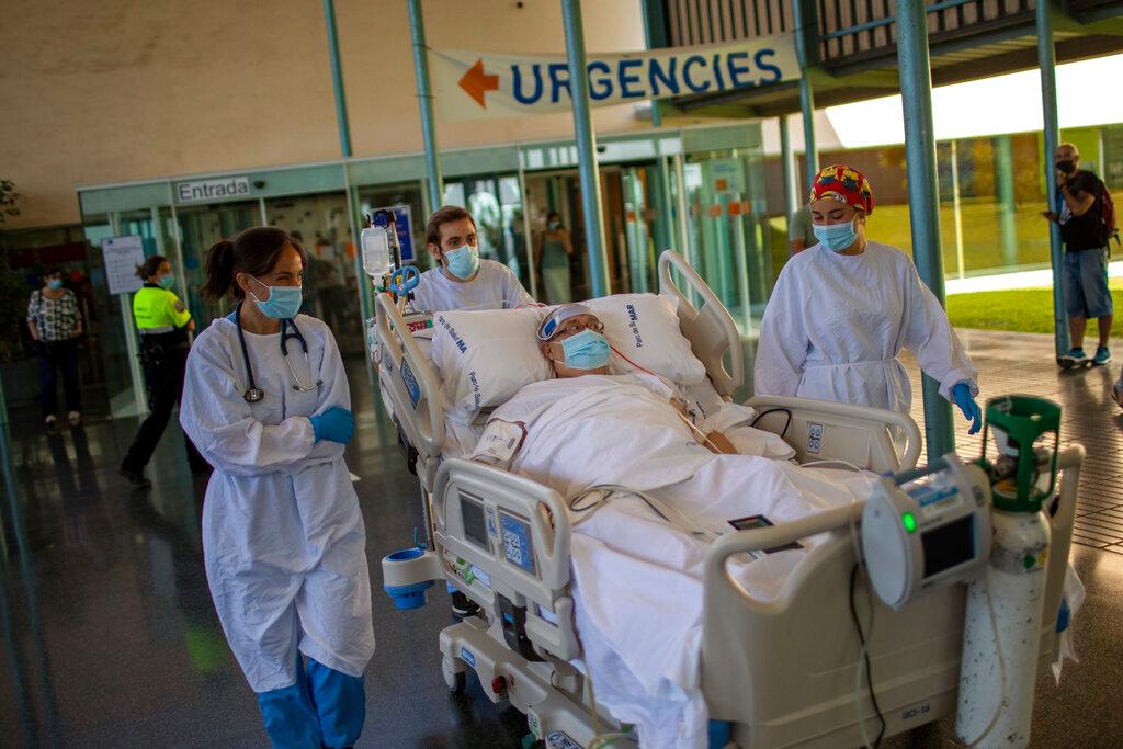 Medical staff transport Francisco España to see the Mediterranean sea at the "Hospital del Mar." (Emilio Morenatti/AP)