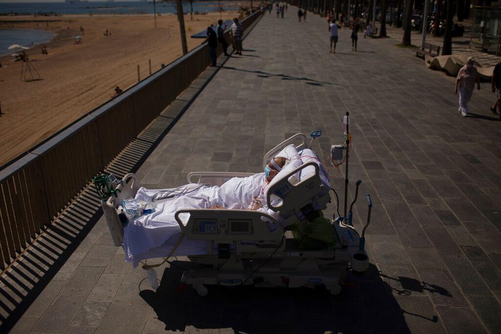 Francisco España spends time in front of the beach. (Emilio Morenatti/AP)