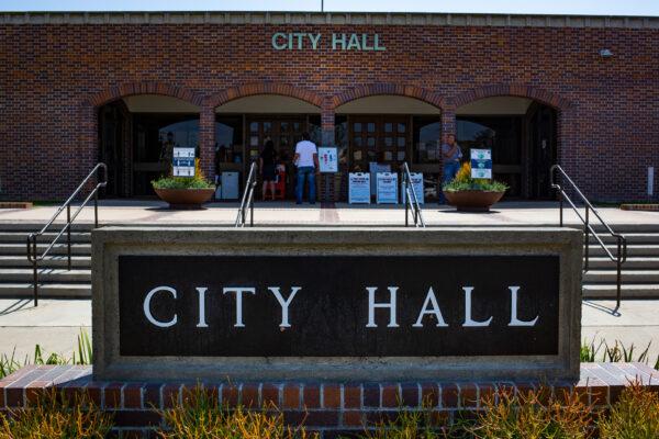 Visitors peer through the windows of City Hall in Westminster, Calif., on Sept. 3, 2020. (John Fredricks/The Epoch Times)