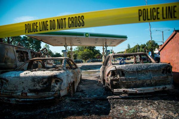 Cars stand burned in the lot of a BP gas station after rioters clashed with the Milwaukee Police Department protesting an officer-involved killing in Milwaukee, on Aug. 14, 2016. (Darren Hauck/Getty Images)