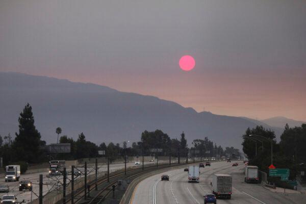  Smoke from wildfires burning east of Los Angeles dims the sunrise seen from Pasadena, Calif., on Sept. 7, 2020. (John Antczak/AP Photo)