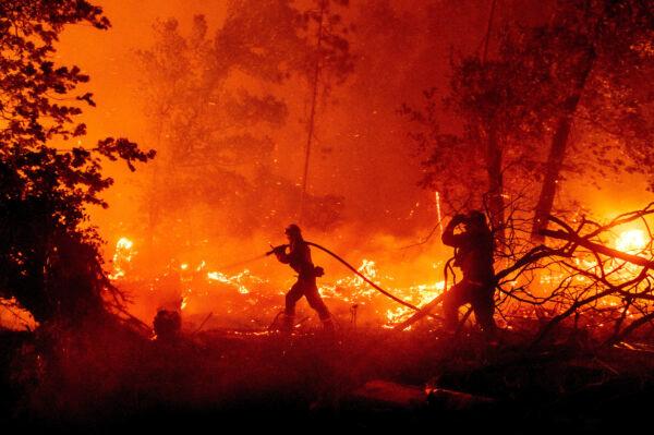 Firefighters battle the Creek Fire as it threatens homes in the Cascadel Woods neighborhood of Mariposa County, Calif., on Sept. 7, 2020. (Noah Berger/AP Photo)