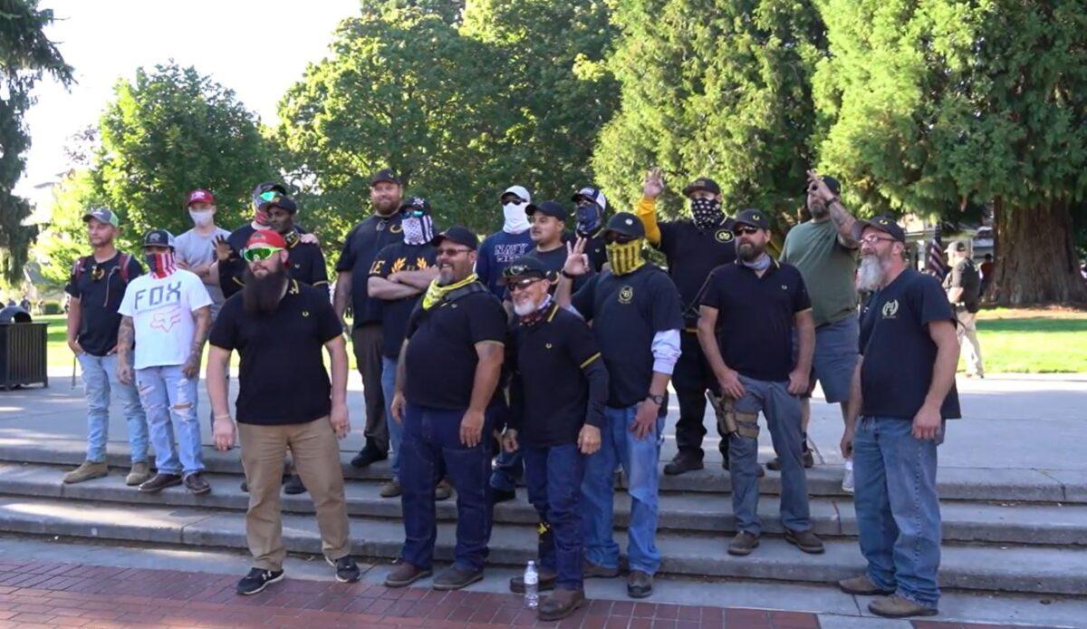 In this still image from video, a group of Proud Boys pose for pictures at a memorial for Aaron Danielson in Vancouver, Wash., Sept. 5, 2020. (The Epoch Times)