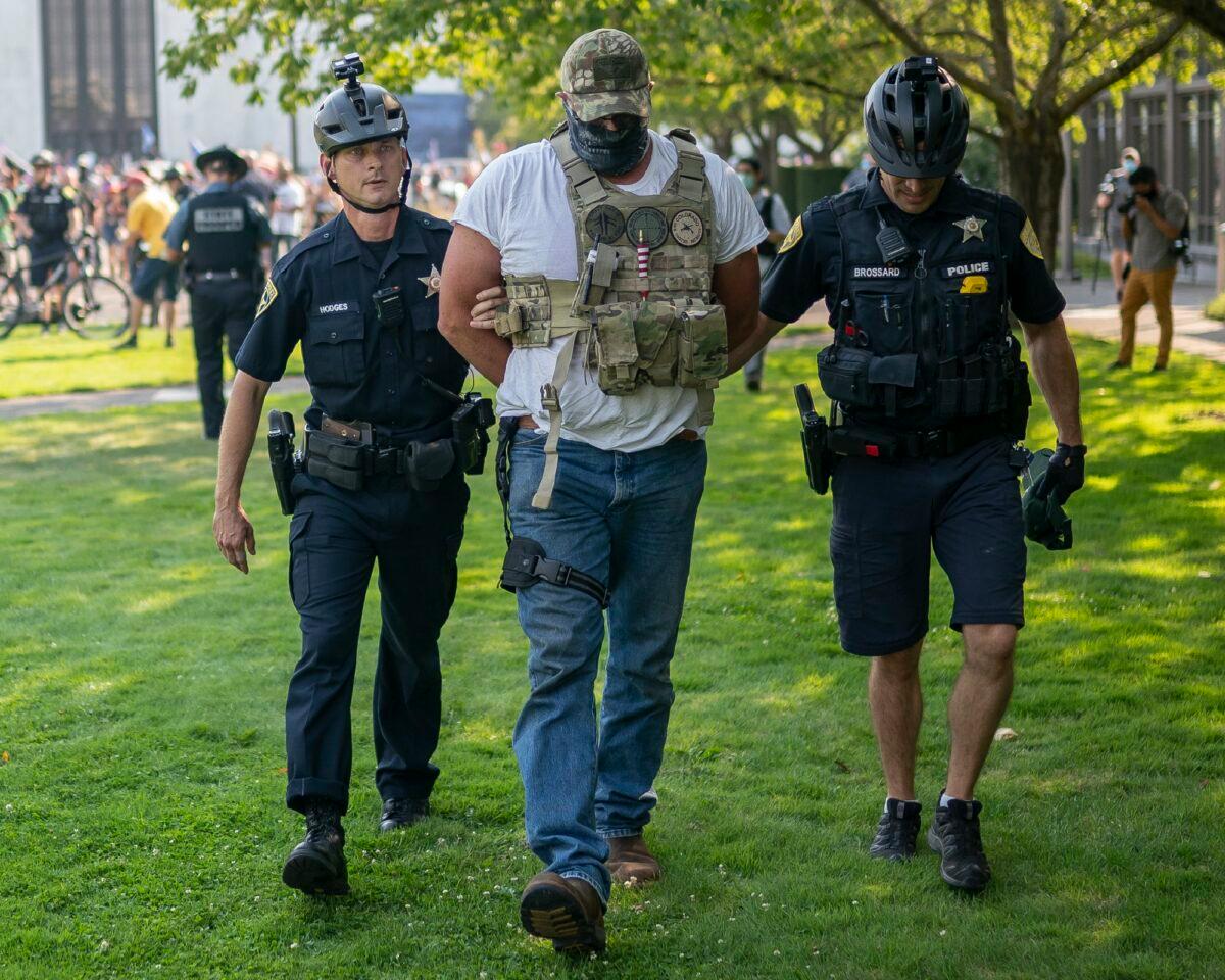 Oregon State Troopers and Salem police arrest a man during a pro-President Donald Trump rally in Salem, Ore., on Sept. 7, 2020. (Nathan Howard/Getty Images)