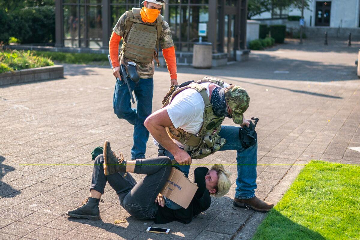 A man attacks a counter-protester during a pro-President Donald Trump rally in Salem, Ore., on Sept. 7, 2020. (Nathan Howard/Getty Images)