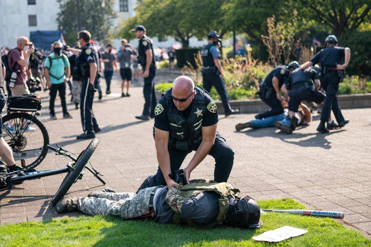  Police arrest a demonstrator after a clash with counter-protesters during a rally in Salem, Ore., on Sept. 7, 2020. (Nathan Howard/Getty Images)