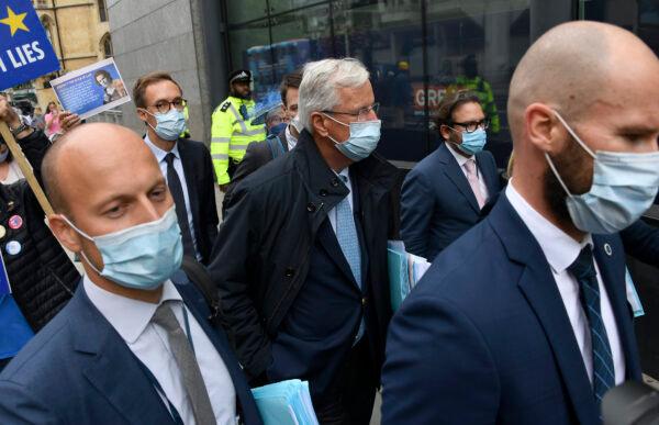 EU chief negotiator Michel Barnier, center, is surrounded by delegates and pro-EU protesters as he arrives at the Westminster Conference Center in London, on Sept. 9, 2020. (Alberto Pezzali/ AP Photo)