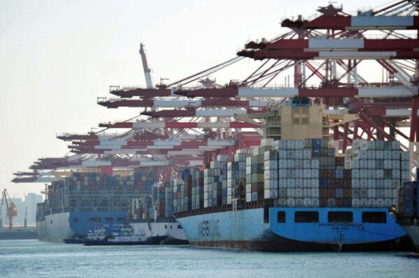 Cargo containers are loaded on container ships at a port in Qingdao, a city in eastern China's Shandong Province, on April 8, 2018. (AFP via Getty Images)