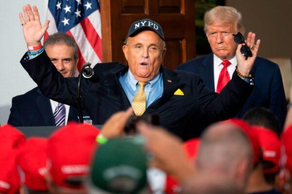 US President Donald Trump (R) listens as his personal lawyer Rudy Giuliani speaks to the City of New York Police Benevolent Association at the Trump National Golf Club in Bedminster, NJ, on Aug. 14, 2020. (Jim Watson/AFP via Getty Images)