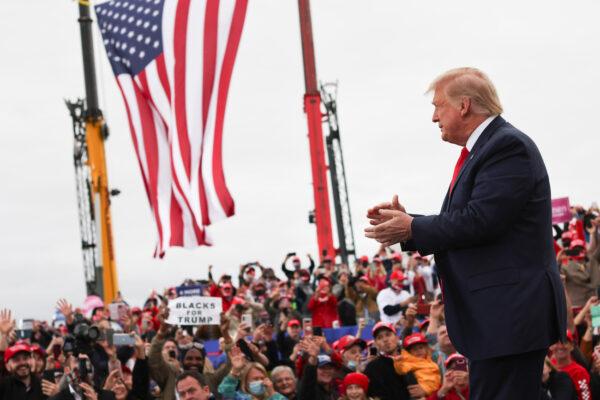 President Donald Trump applauds as he arrives at a campaign event at MBS International Airport, in Freeland, Michigan, on Sept. 10, 2020. (Jonathan Ernst/Reuters)