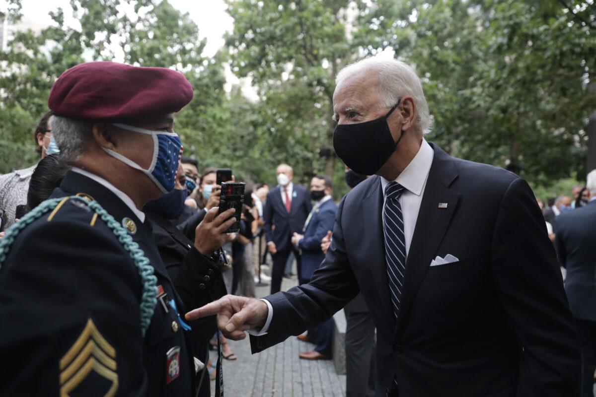 Democratic presidential nominee Joe Biden meets with an attendee at a 9/11 memorial service at the National September 11 Memorial and Museum in New York, Sept. 11, 2020. (Amir Alfiky/Pool/Getty Images)