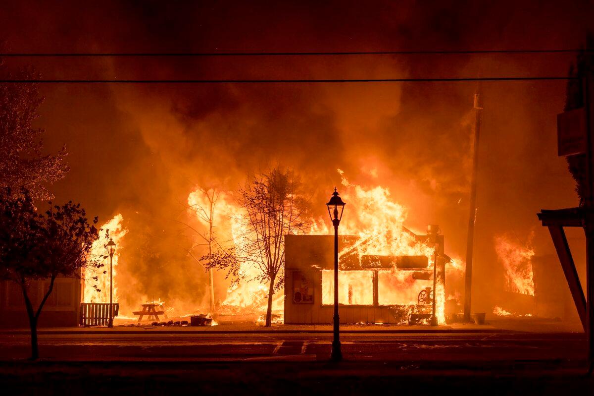  Buildings are engulfed in flames as a wildfire ravages the central Oregon town of Talent near Medford, Ore., on Sept. 8, 2020. (Kevin Jantzer via AP)