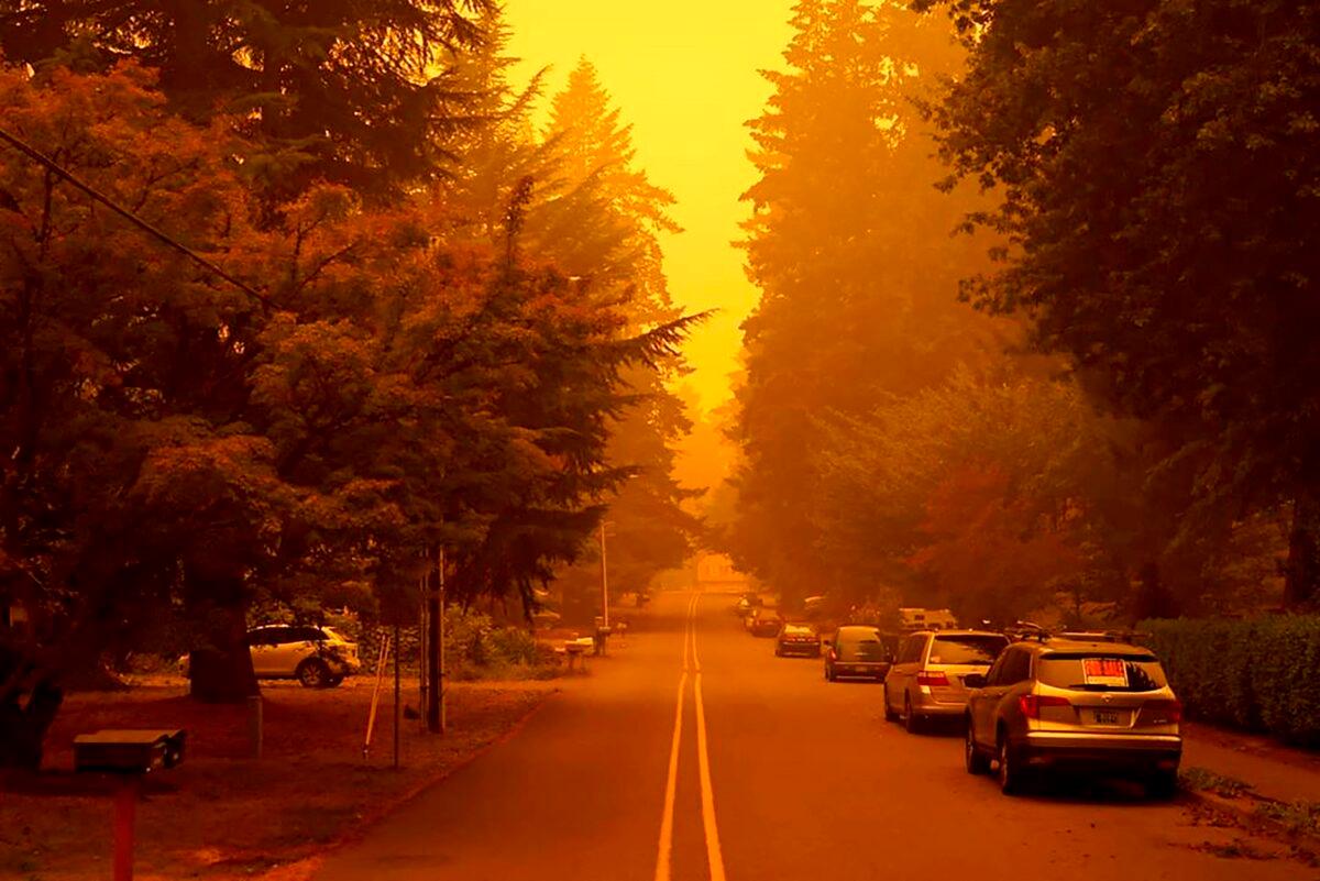 A street is shrouded by smoke from wildfires in West Linn, Ore., Sept. 10, 2020. (Christian Gallagher via AP)