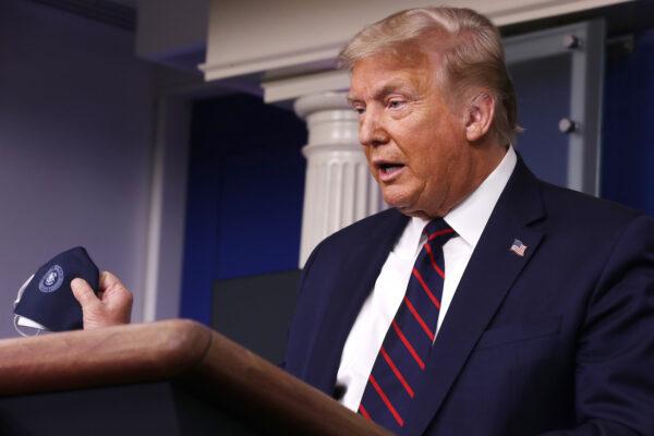 President Donald Trump talks to holds up his face mask during a press conference in the Brady Press Briefing Room at the White House in Washington, on July 21, 2020. (Chip Somodevilla/Getty Images)