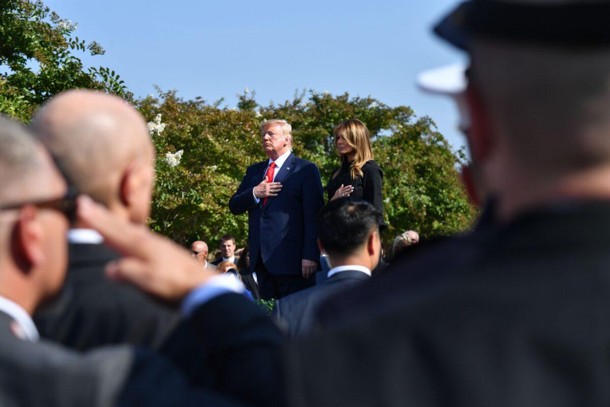 President Donald Trump and First Lady Melania Trump listen to the national anthem during a ceremony marking the 18th anniversary of the 9/11 attacks, at the Pentagon in Washington on Sept. 11, 2019. (Nicholas Kamm/AFP via Getty Images)