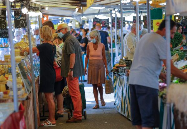 People wearing protective face masks as precaution against the conoravirus shop at a outdoor market in Versailles, Paris, on Sept. 11, 2020. (Michel Euler/AP Photo)