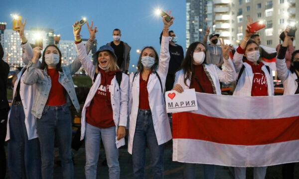 Belarusian medical workers gesture during a rally in support of Maria Kolesnikova, and other members of the Coordination Council created by the opposition, in Minsk, Belarus, on Sept. 9, 2020. (AP Photo)