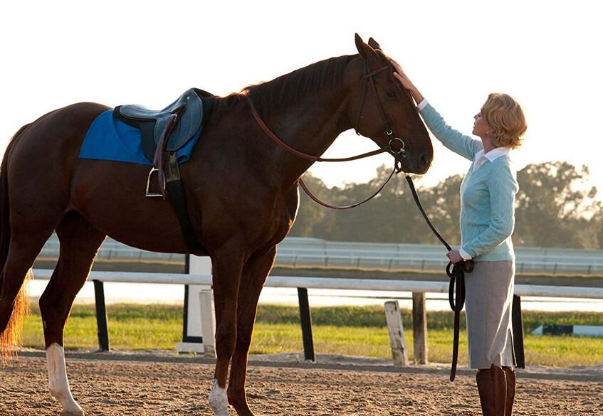 Diane Lane, who plays Penny Chenery, standing with one of the five horse actors portraying Secretariat, in "Secretariat." (Walt Disney Studios Motion Pictures)